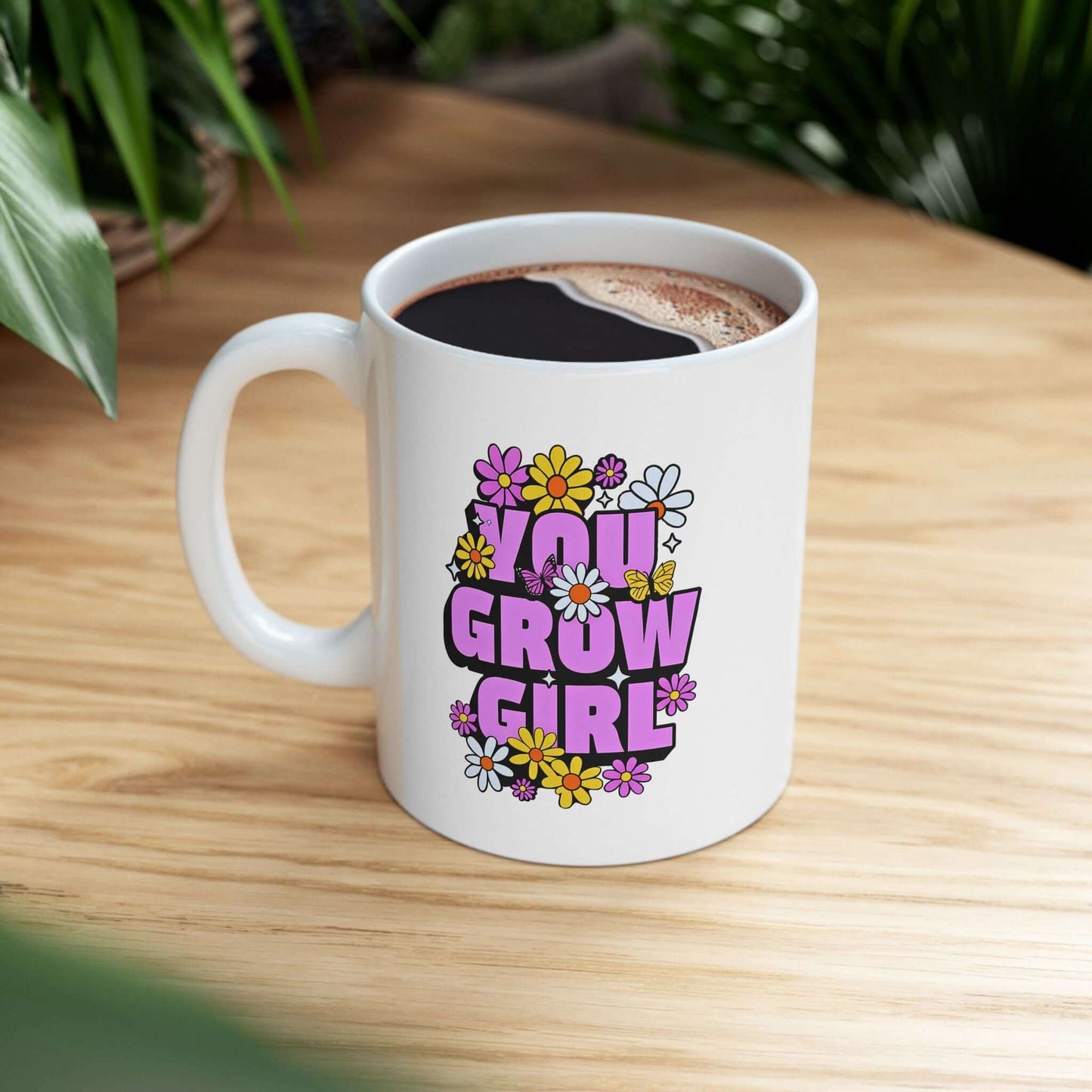 white ceramic mug featuring the text ‘YOU GROW GIRL’ in bold purple letters surrounded by colorful