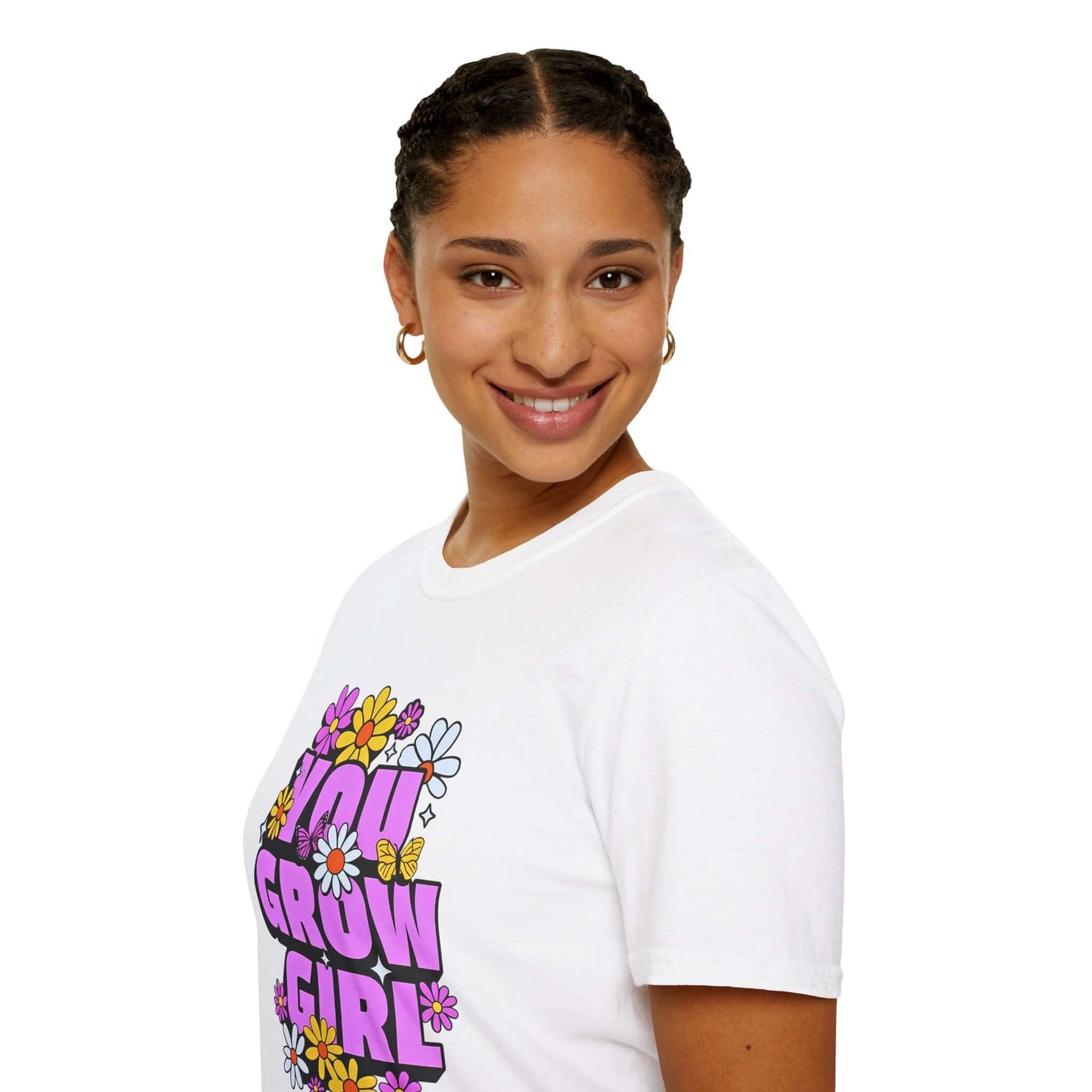 Woman wearing a white t-shirt displaying the phrase ‘YOU GROW GIRL’ in bold purple letters surrounded by colorful flowers.