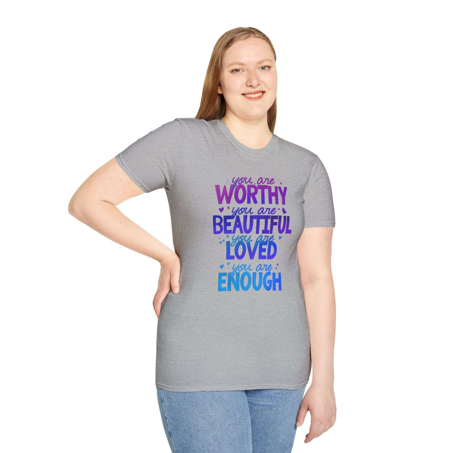Gray t-shirt featuring the text ‘You are Worthy, You are Beautiful, You are Loved, You are Enough’ in purple and blue font, worn by a smiling model.
