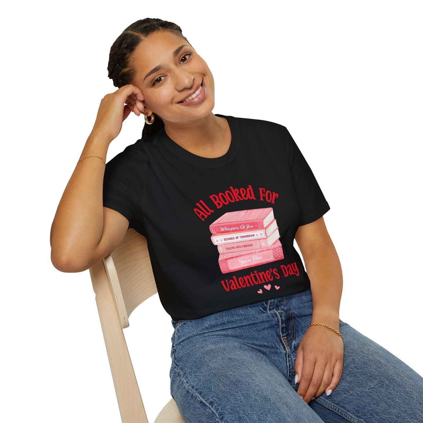 Woman wearing a black t-shirt featuring the text ‘All Booked for Valentine’s Day’ with a graphic of stacked red and pink books.