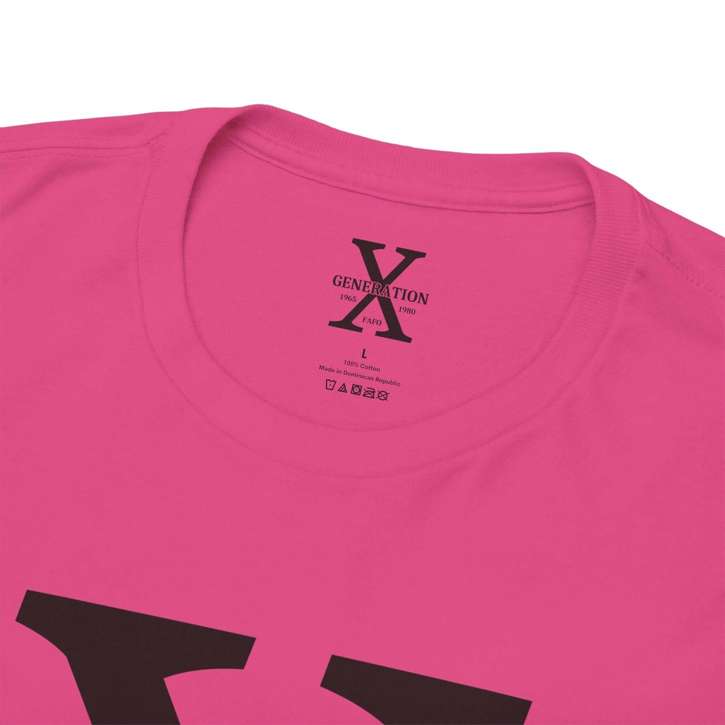 A pink t-shirt with a large black “X” on the front, representing Generation X. The inside collar features a printed label with the same “Generation X” design, size details, and care instructions.