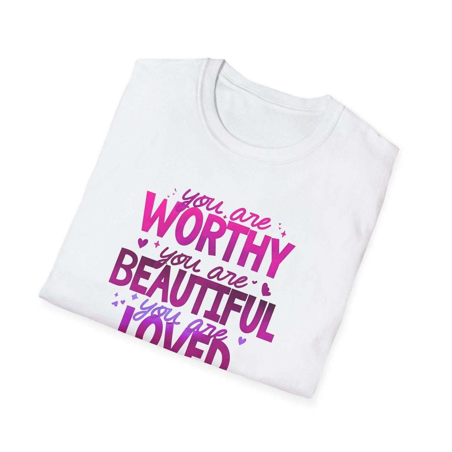 Folded white unisex t-shirt featuring an inspirational design with the text ‘You are Worthy, You are Beautiful, You are Loved, You are Enough’ in pink and purple.
