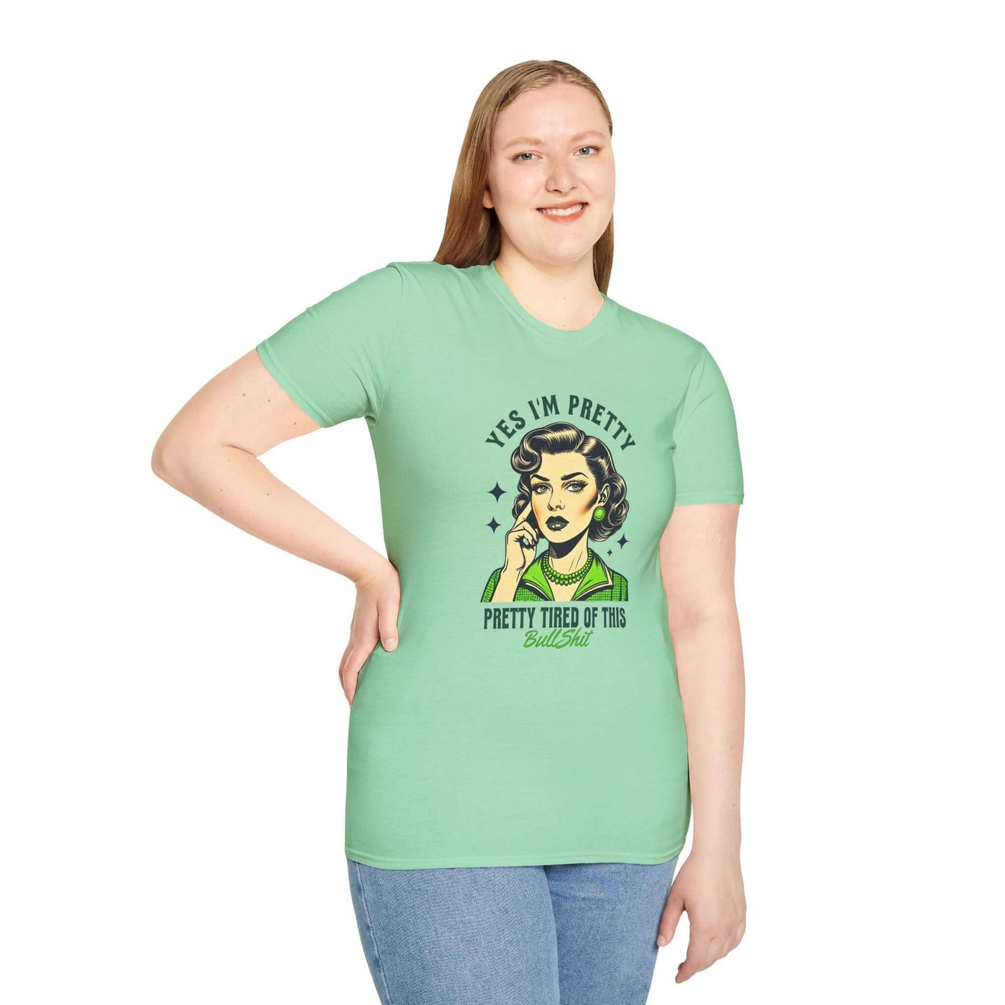 Smiling woman wearing a mint green unisex t-shirt featuring a retro-style design with the text ‘Yes, I’m Pretty Tired of This Bullsh*t’ in green.