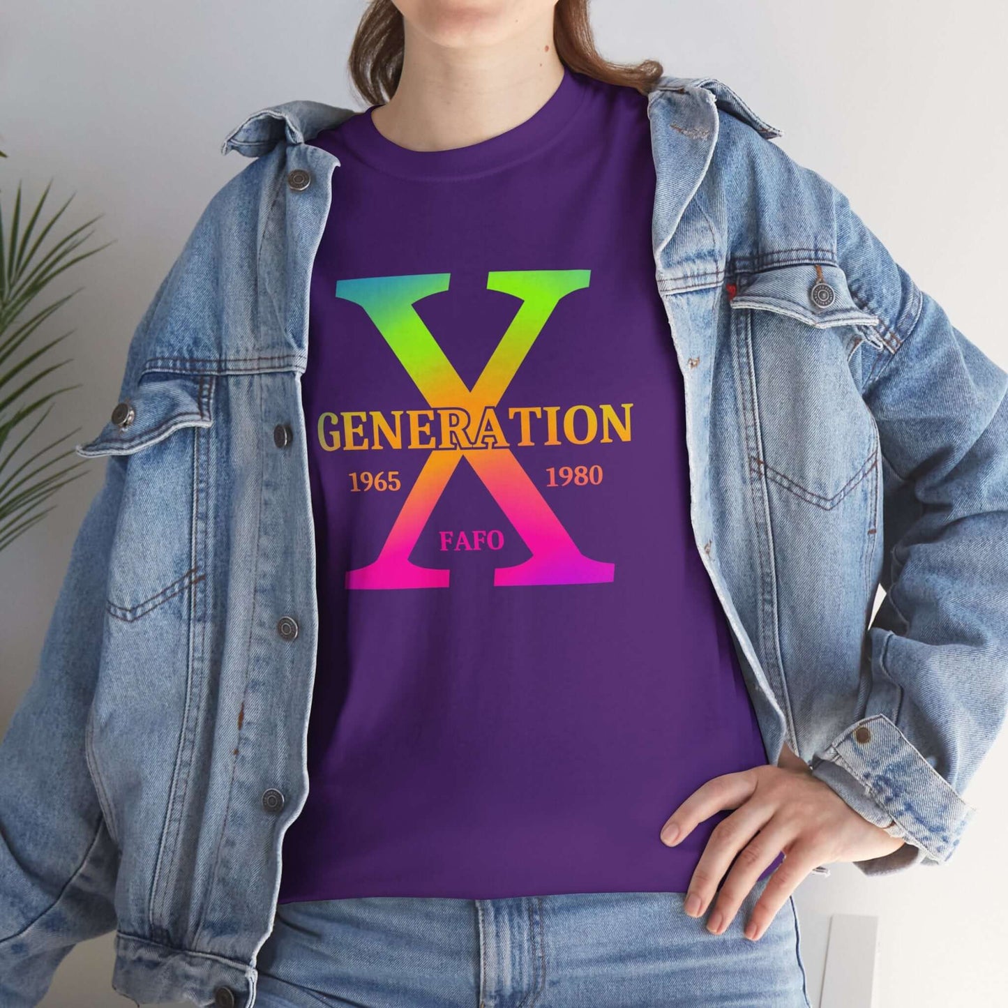 A woman with a relaxed expression wears a jean jacket and a purple t-shirt featuring a bold rainbow gradient “GENERATION X” design with “FAFO” underneath. The design is centered on the chest, embracing Gen X pride with a clean and minimalistic look.