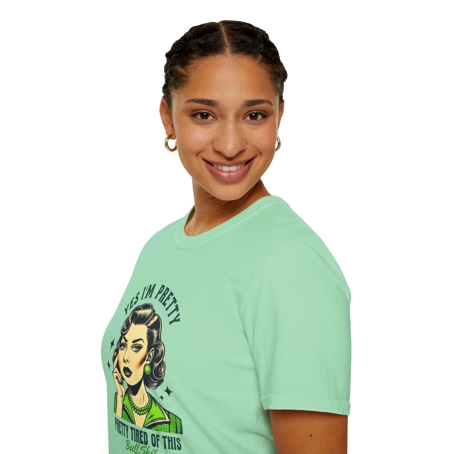 Smiling woman wearing a mint unisex t-shirt featuring a retro-style design with the text ‘Yes, I’m Pretty Tired of This Bullsh*t’ in green.