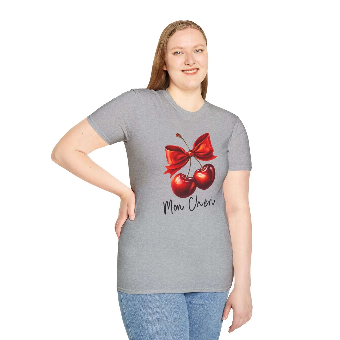 Smiling woman wearing a gray unisex t-shirt featuring a stylish ‘Mon Chéri’ design with two vibrant red cherries tied with a bow and elegant text.