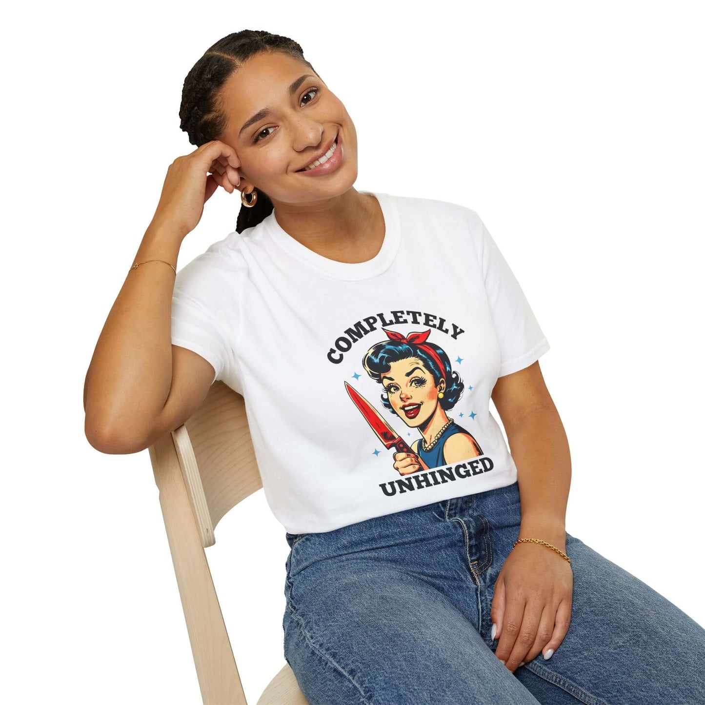 Smiling woman wearing a white unisex t-shirt featuring a retro ‘Completely Unhinged’ design with a vintage-style woman holding a red knife and bold text.