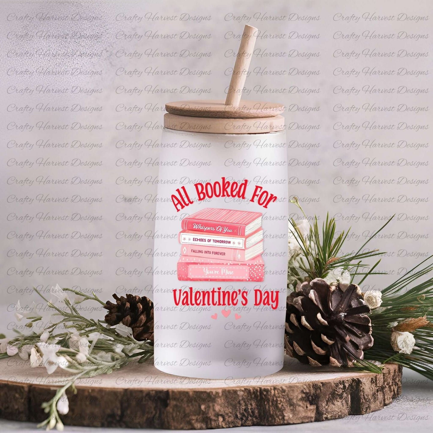 Glass can with a wooden lid and straw featuring the ‘All Booked for Valentine’s Day’ design with a stack of pink books and romantic titles. Displayed on a rustic wooden surface with pinecones and greenery.