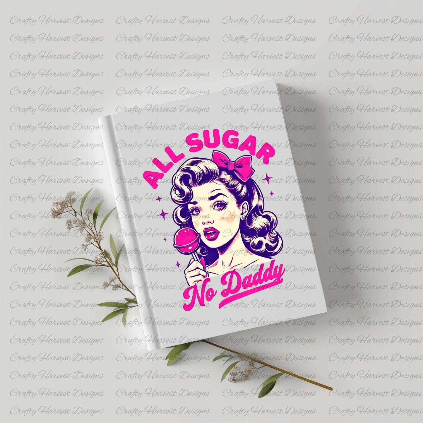 White hardcover notebook featuring a retro-inspired digital design of a vintage-style woman holding a lollipop, with the bold text ‘All Sugar No Daddy’ in pink and purple. The notebook is displayed on a light surface with small sprigs of greenery, highlighting its use as a stylish and functional stationery item.