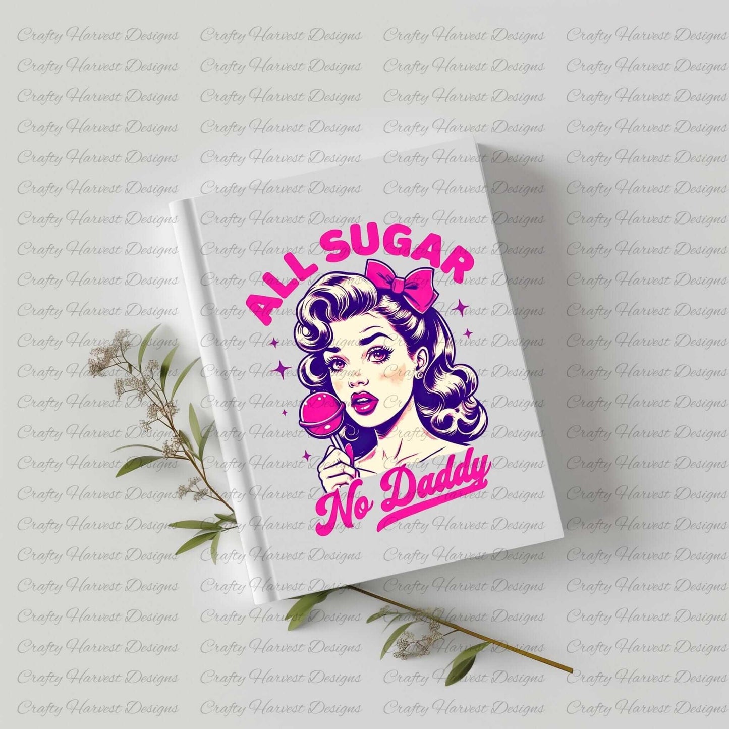 White hardcover notebook featuring a retro-inspired digital design of a vintage-style woman holding a lollipop, with the bold text ‘All Sugar No Daddy’ in pink and purple. The notebook is displayed on a light surface with small sprigs of greenery, highlighting its use as a stylish and functional stationery item.