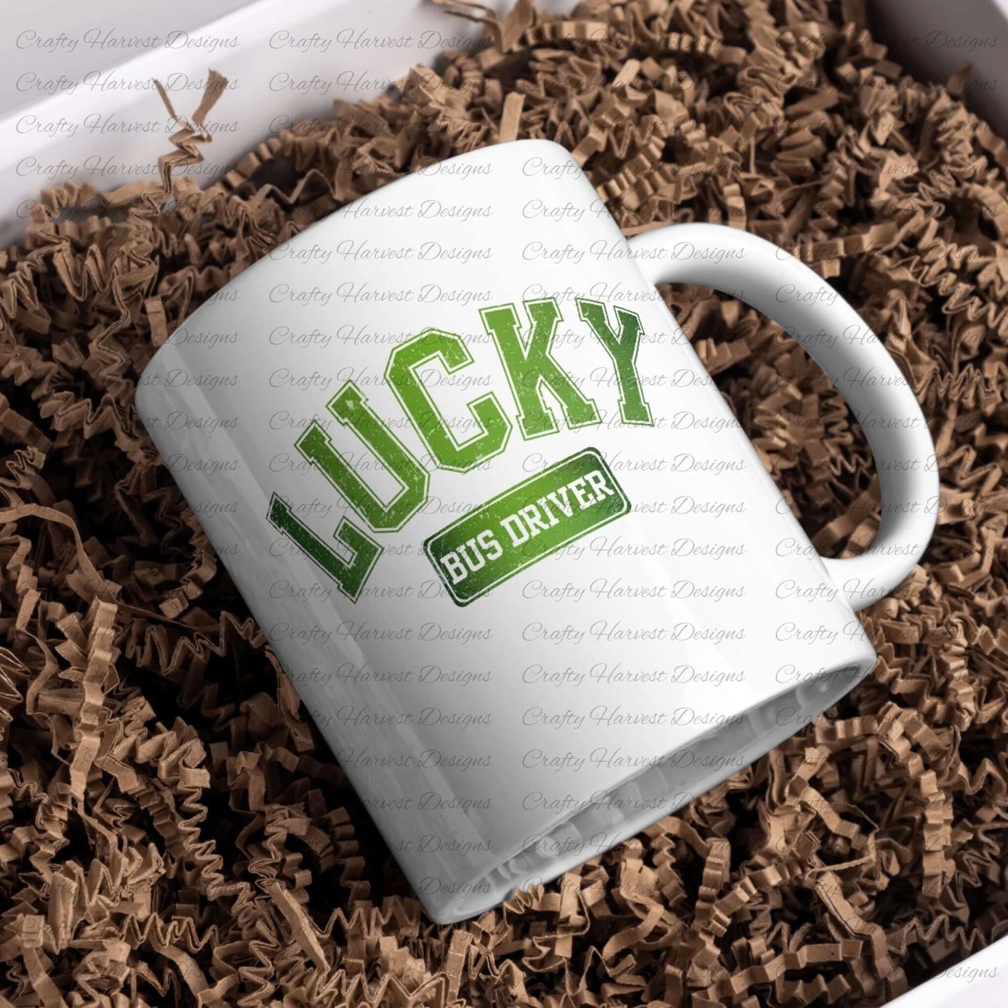 White ceramic mug featuring the ‘Lucky Bus Driver’ St. Patrick’s Day design in bold green text. The mug is displayed on a bed of brown crinkle paper for a festive presentation.