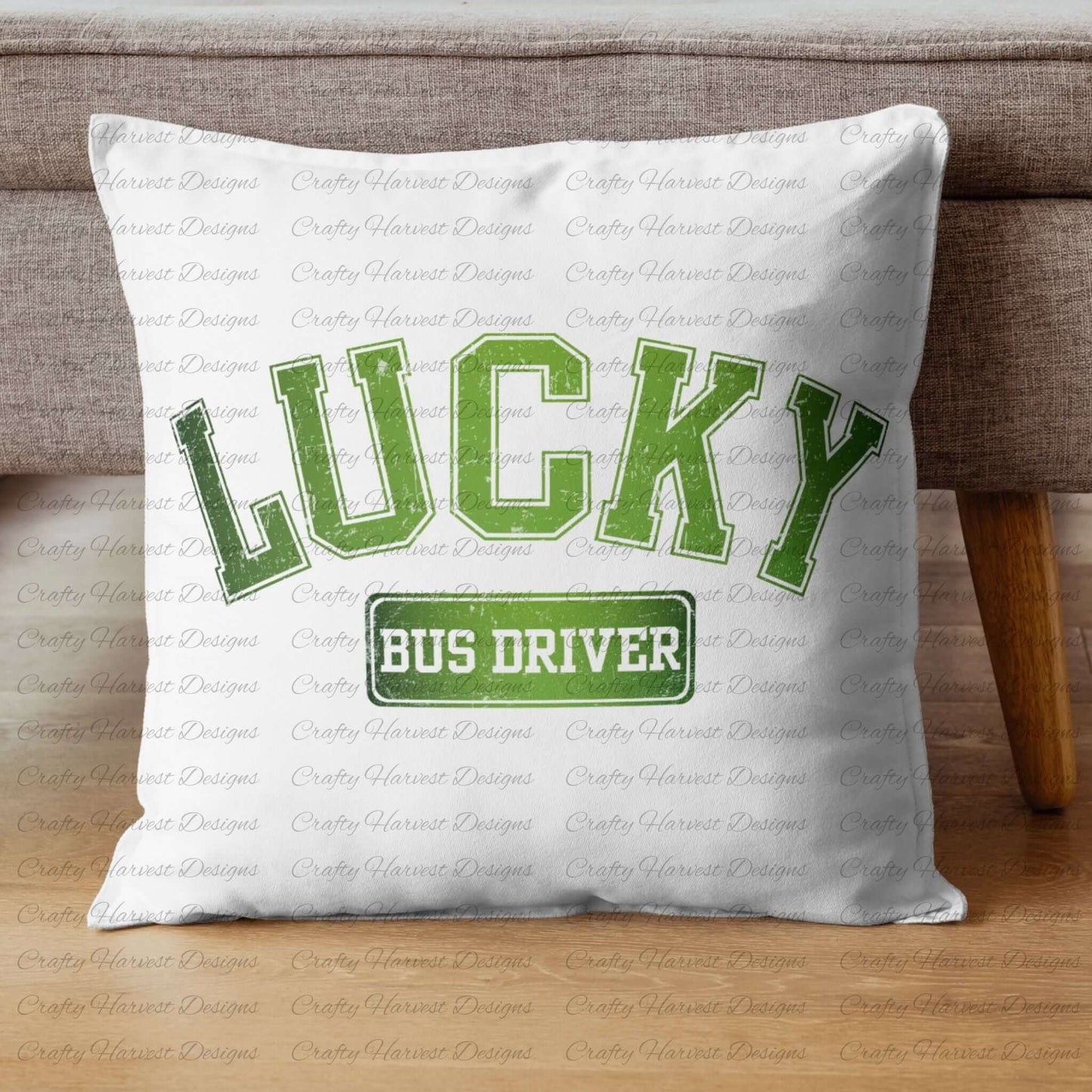 White throw pillow featuring the ‘Lucky Bus Driver’ St. Patrick’s Day design in bold green text. The pillow is displayed on a wooden floor against a gray couch.
