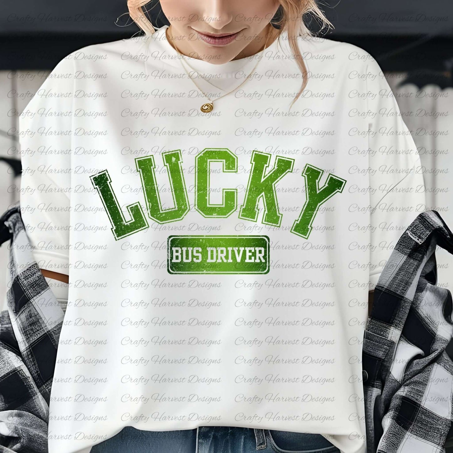 Close-up of a woman wearing a white t-shirt with the ‘Lucky Bus Driver’ St. Patrick’s Day design in bold green text. She is accessorized with a gold necklace and has a plaid shirt draped over her shoulders.