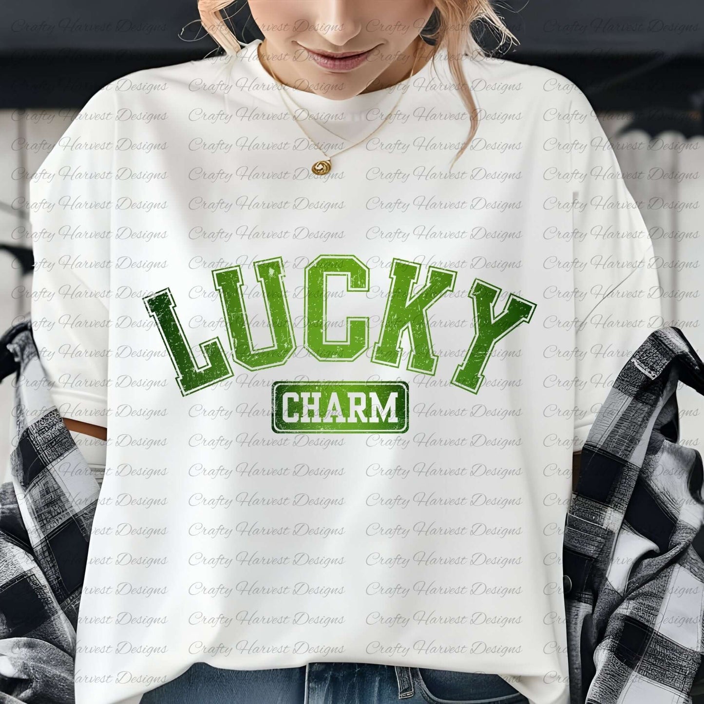 Close-up of a woman wearing a white t-shirt with the ‘Lucky Charm’ St. Patrick’s Day design in bold green text. She is accessorized with a gold necklace and has a plaid shirt draped over her shoulders.