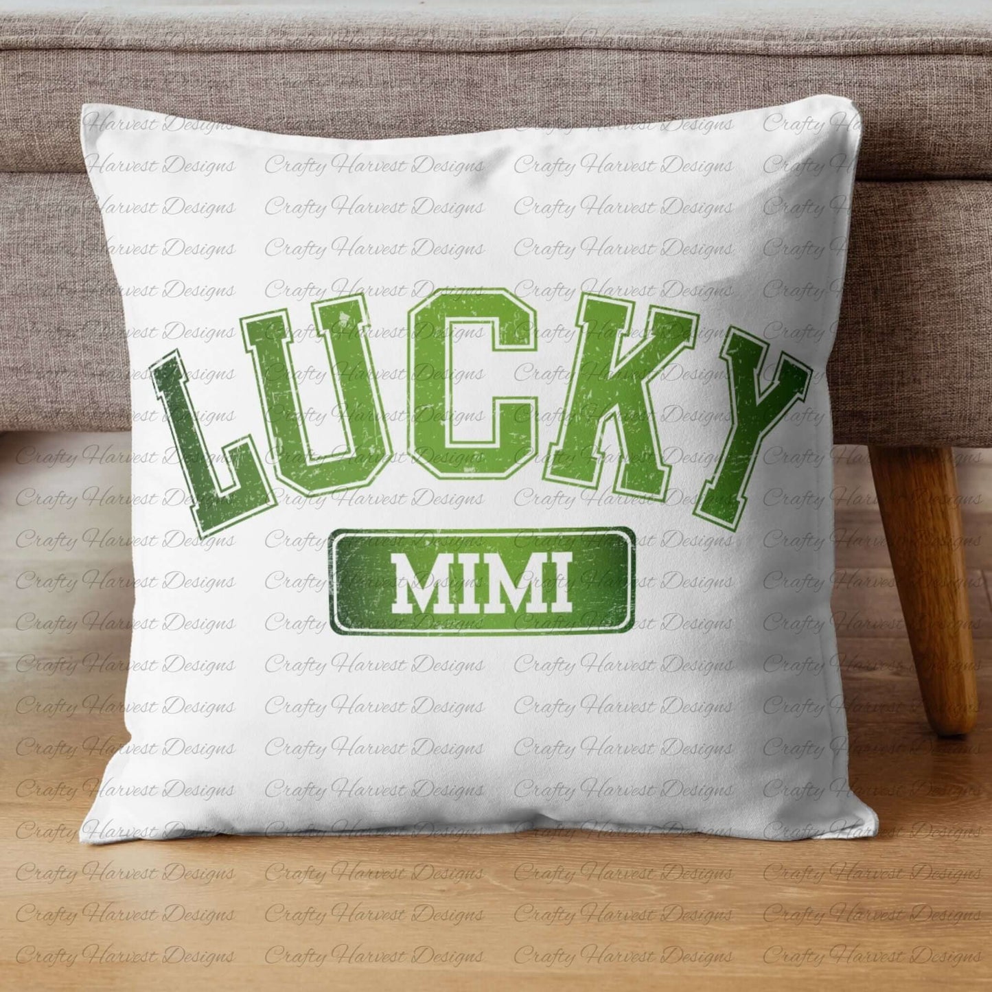 White throw pillow featuring the ‘Lucky Mimi’ St. Patrick’s Day design in bold green text. The pillow is displayed on a wooden floor against a gray couch.
