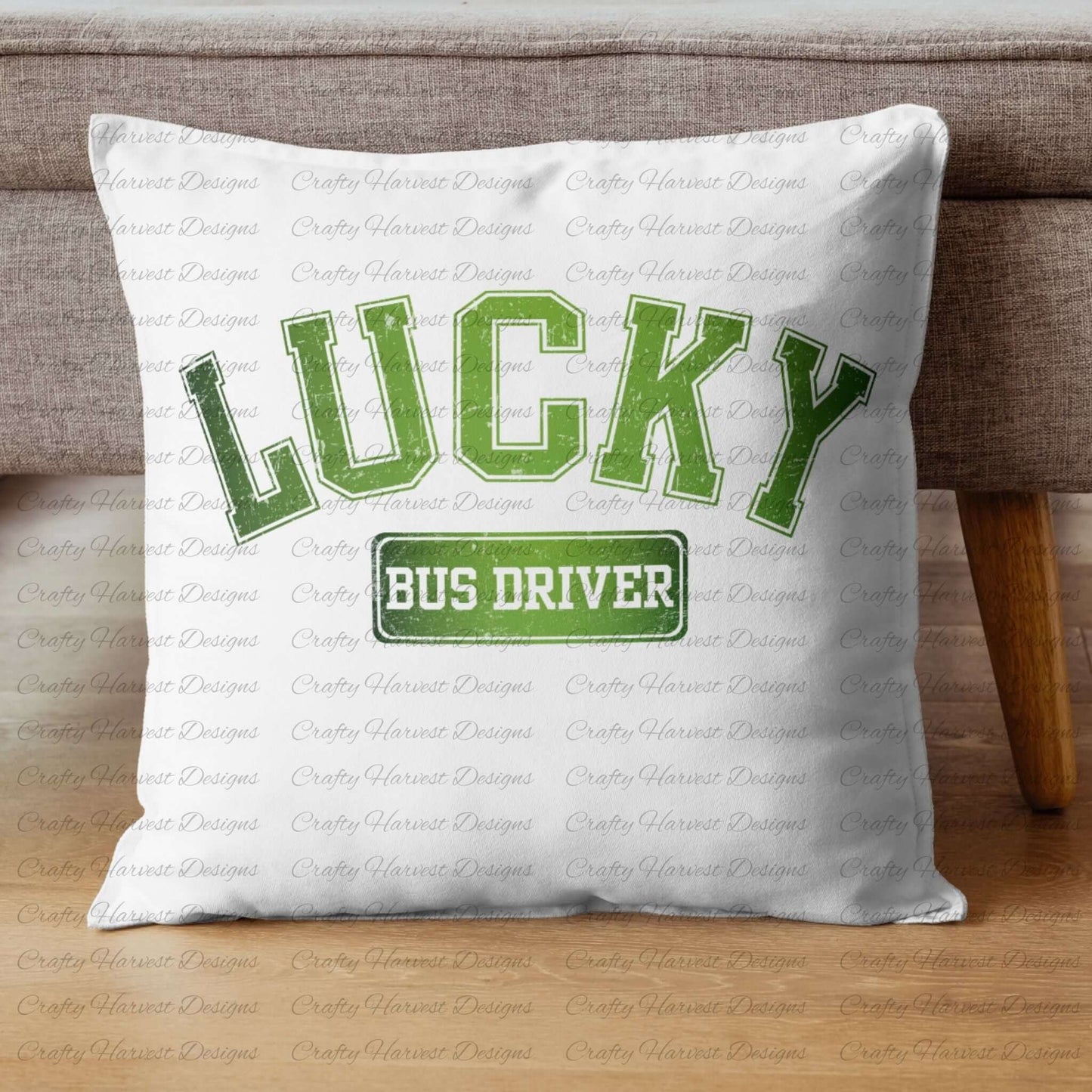 White throw pillow placed on a wooden floor and against a couch, featuring the design ‘Lucky Bus Driver’ in bold green text with a festive St. Patrick’s Day theme.
