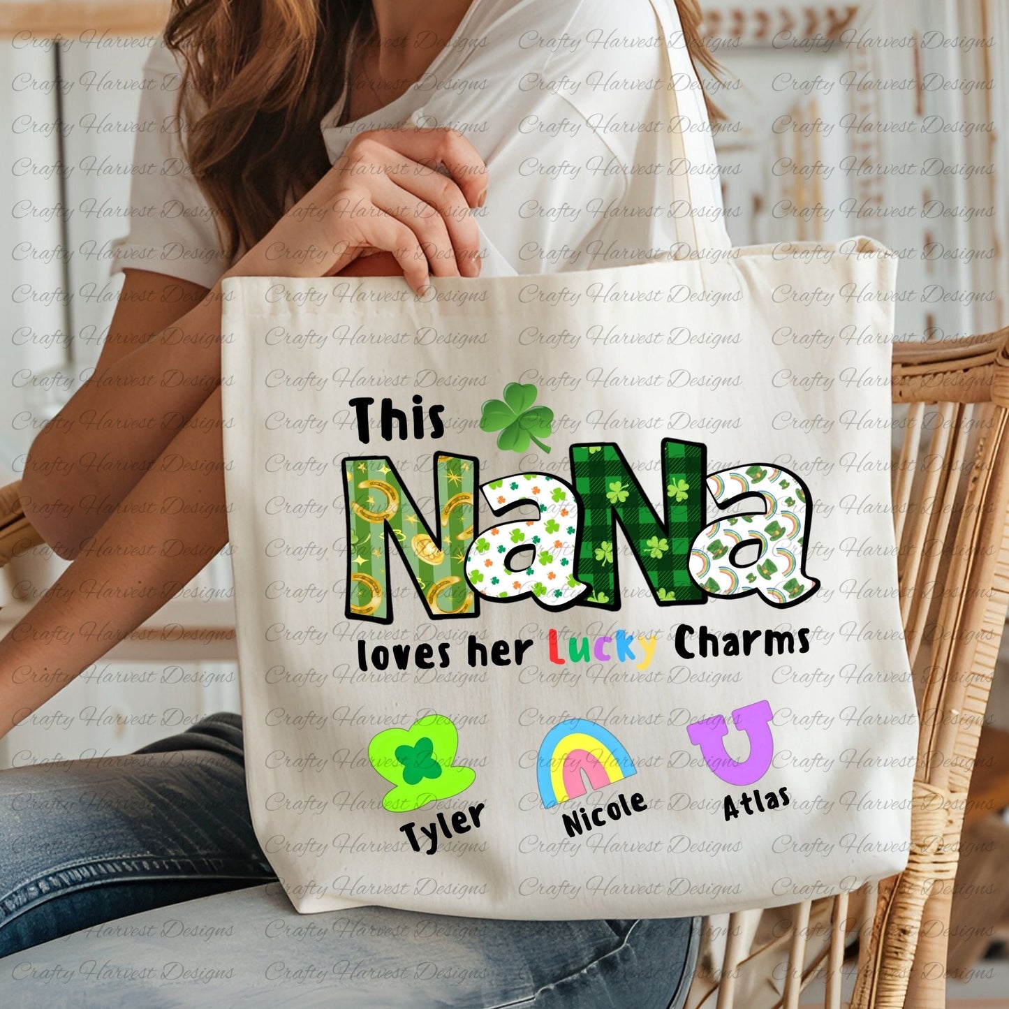 Tote bag with a “This NANA loves her Lucky Charms” design, featuring green-patterned letters and six colorful charm icons with names “Emily” and “Thomas” beneath them.