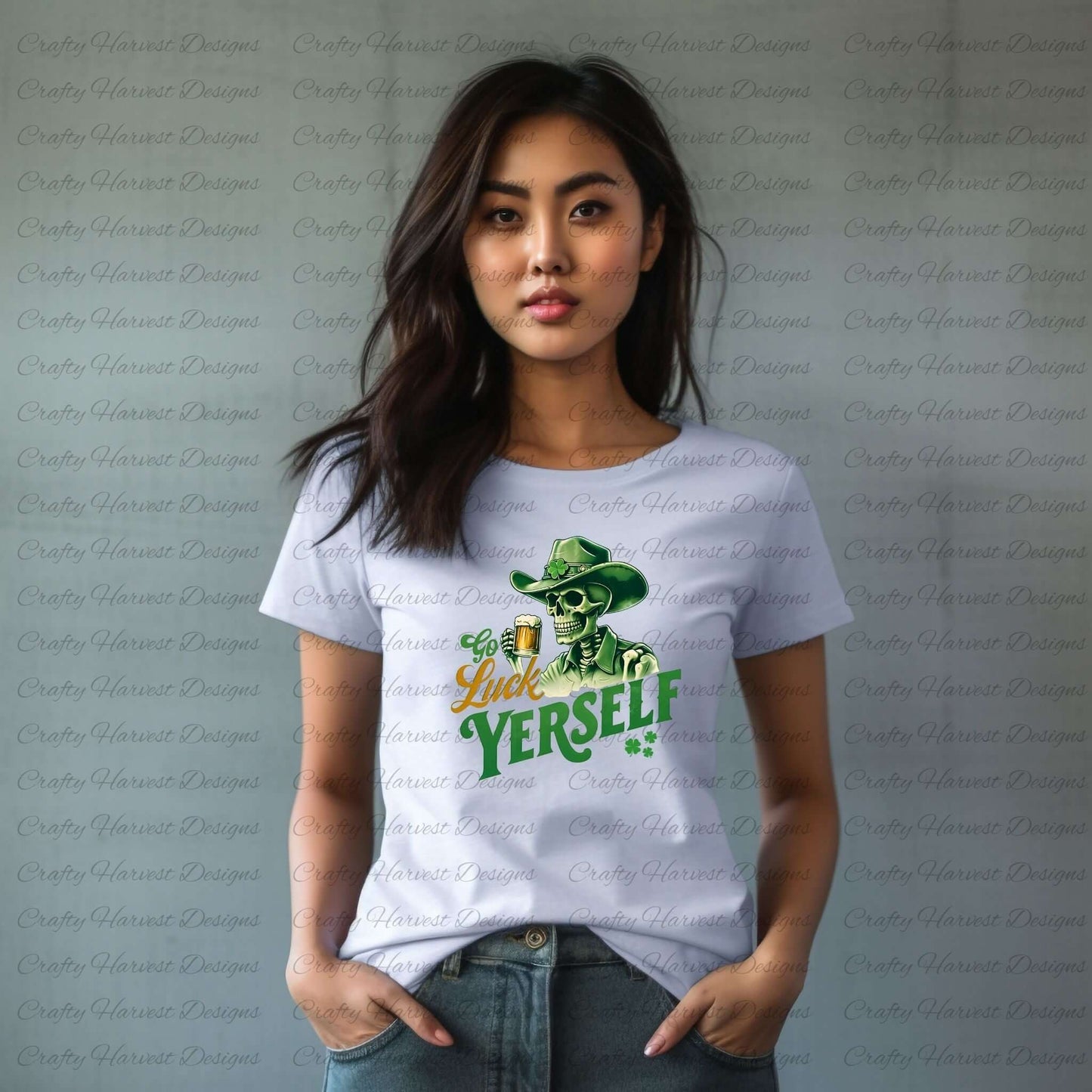 A woman wearing a white t-shirt with a green and yellow graphic design. The design features a skeleton in a cowboy hat with a shamrock, holding a beer mug. The text reads “Go Luck Yourself” with two small shamrocks