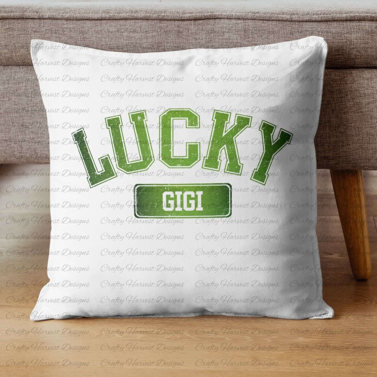 White throw pillow featuring the ‘Lucky Gigi’ St. Patrick’s Day design in bold green text. The pillow is displayed on a wooden floor against a gray couch.
