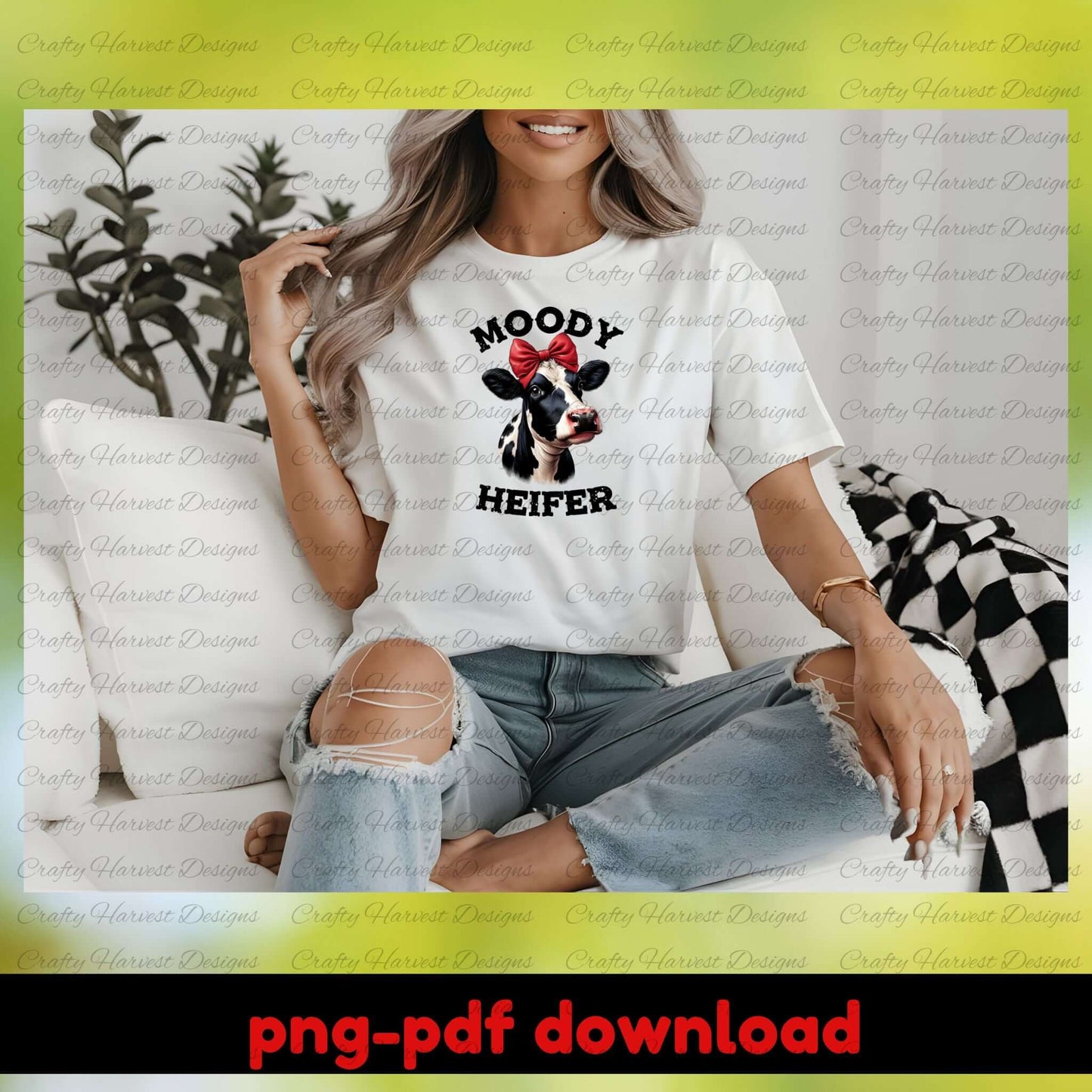 Woman wearing a white t-shirt with a cow graphic and text, sitting on a couch.