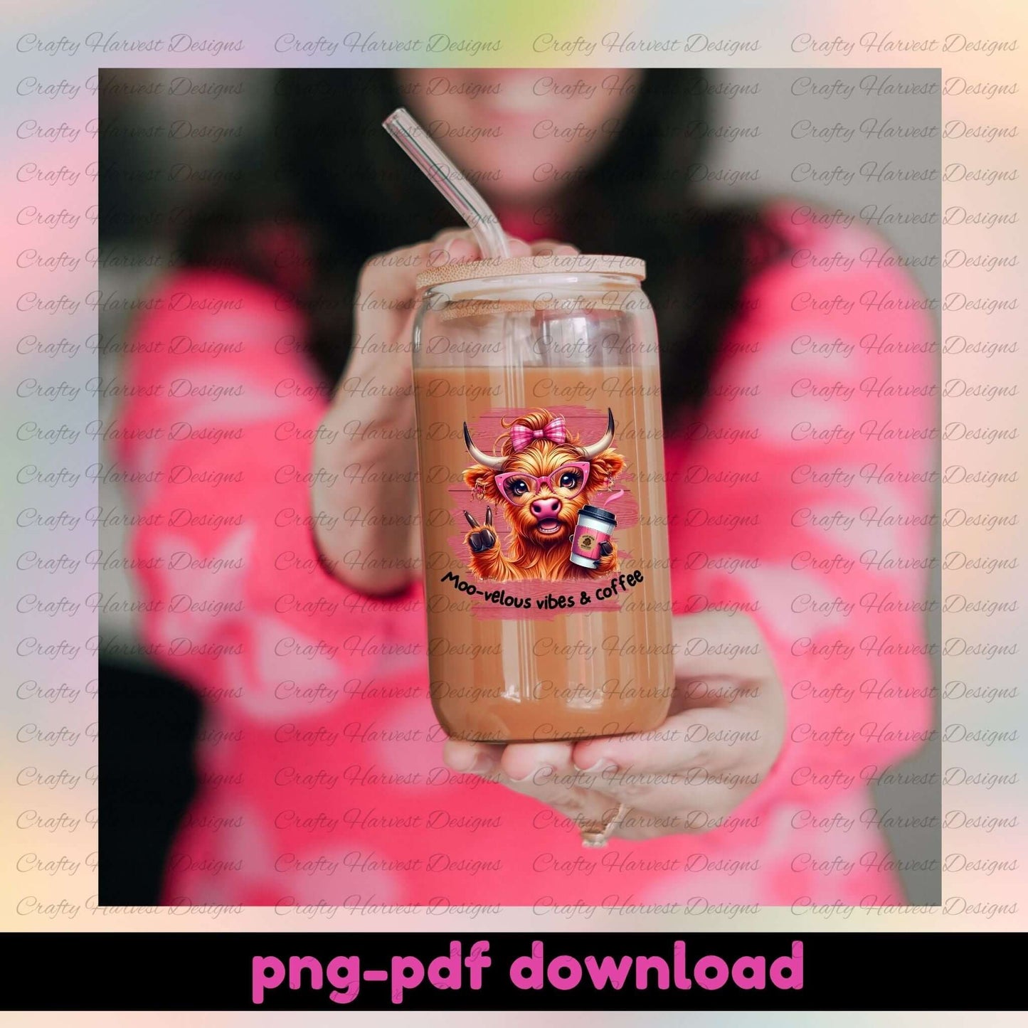 Person holding a tumbler with a cow design and text, against a blurred background.