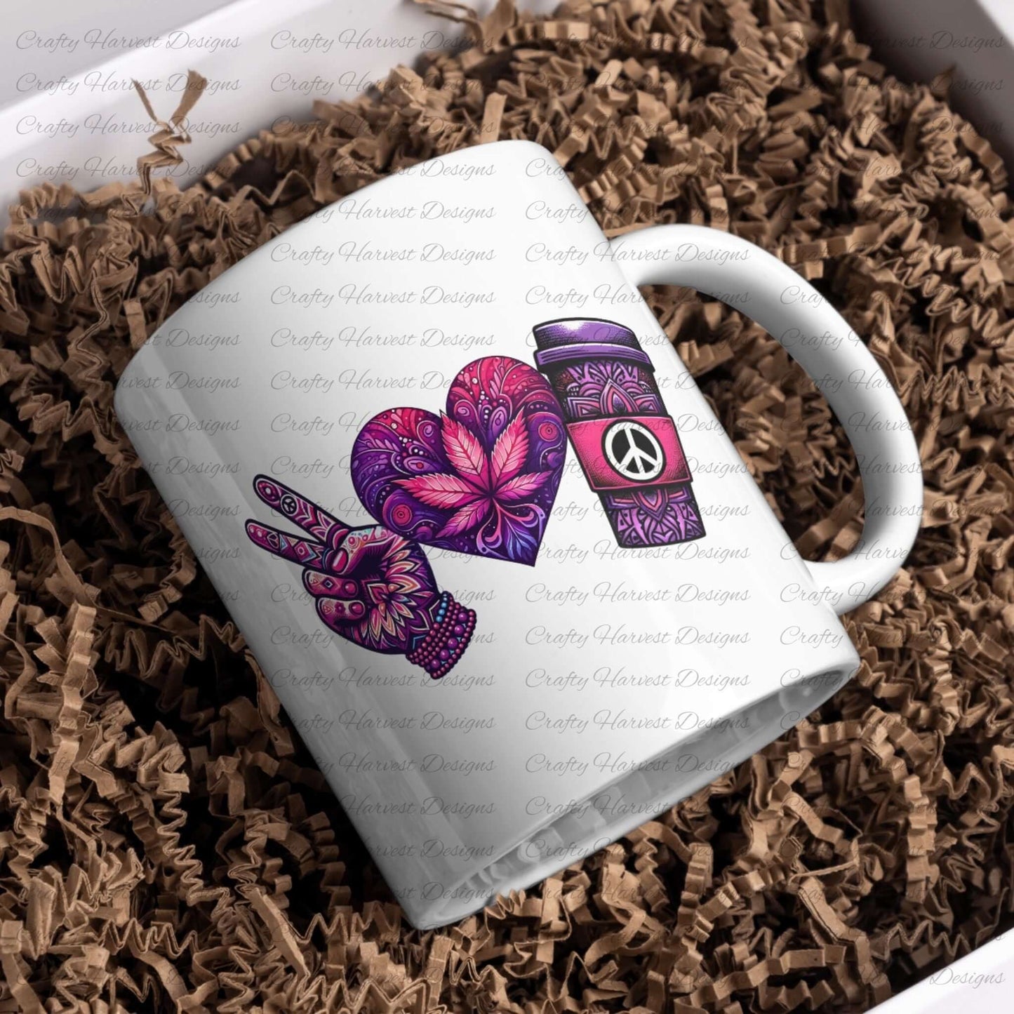 White ceramic mug featuring a peace-themed design in vibrant purple and pink tones. Includes a peace sign hand, a heart with intricate floral patterns, and a coffee cup with a peace symbol, displayed on a bed of crinkled paper packaging.