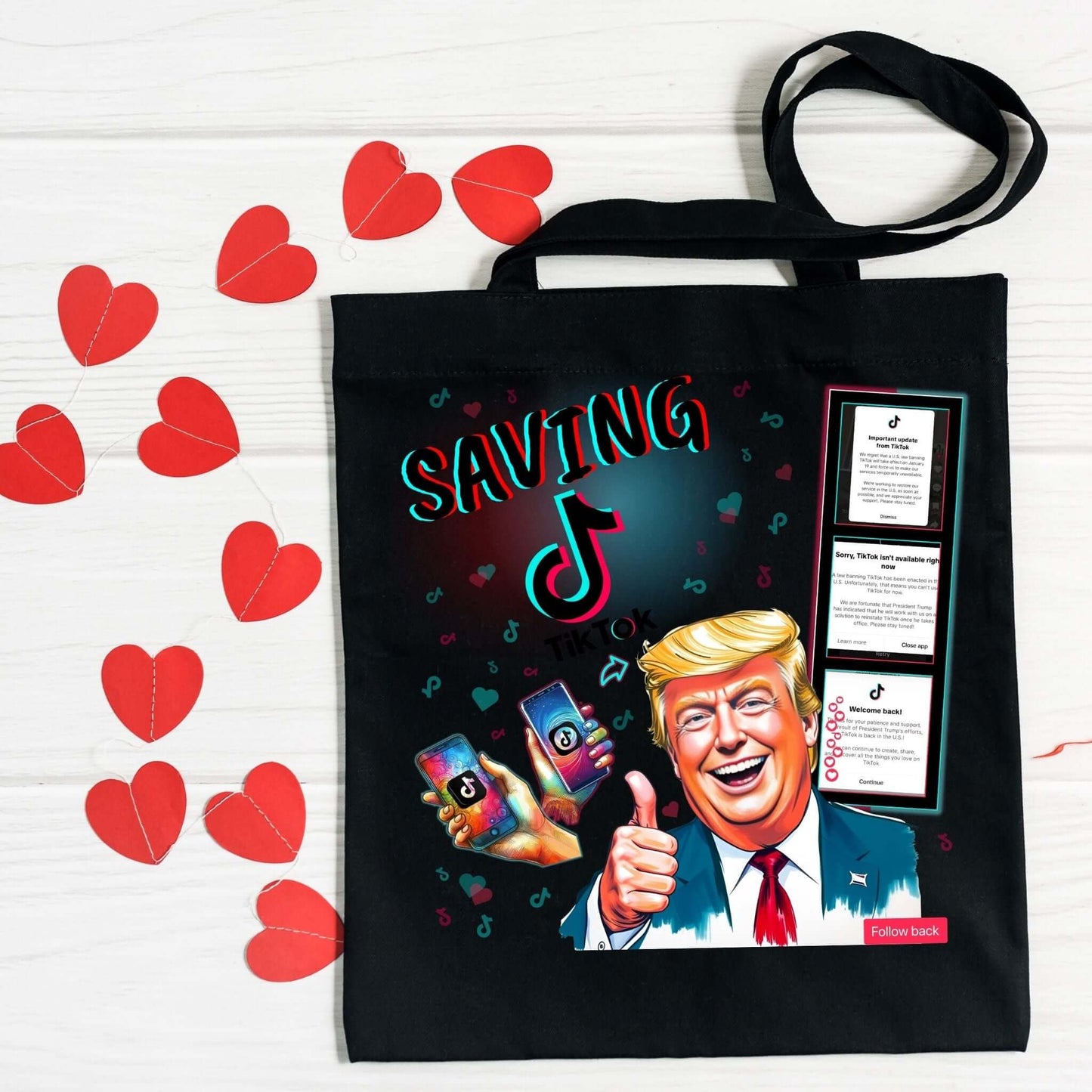 Black tote bag featuring the ‘Saving TikTok’ design with bold text in TikTok-inspired colors, playful icons, hearts, and a caricature of Donald Trump alongside a film strip showcasing TikTok’s reinstatement theme. Perfect for custom bags and social media enthusiasts.