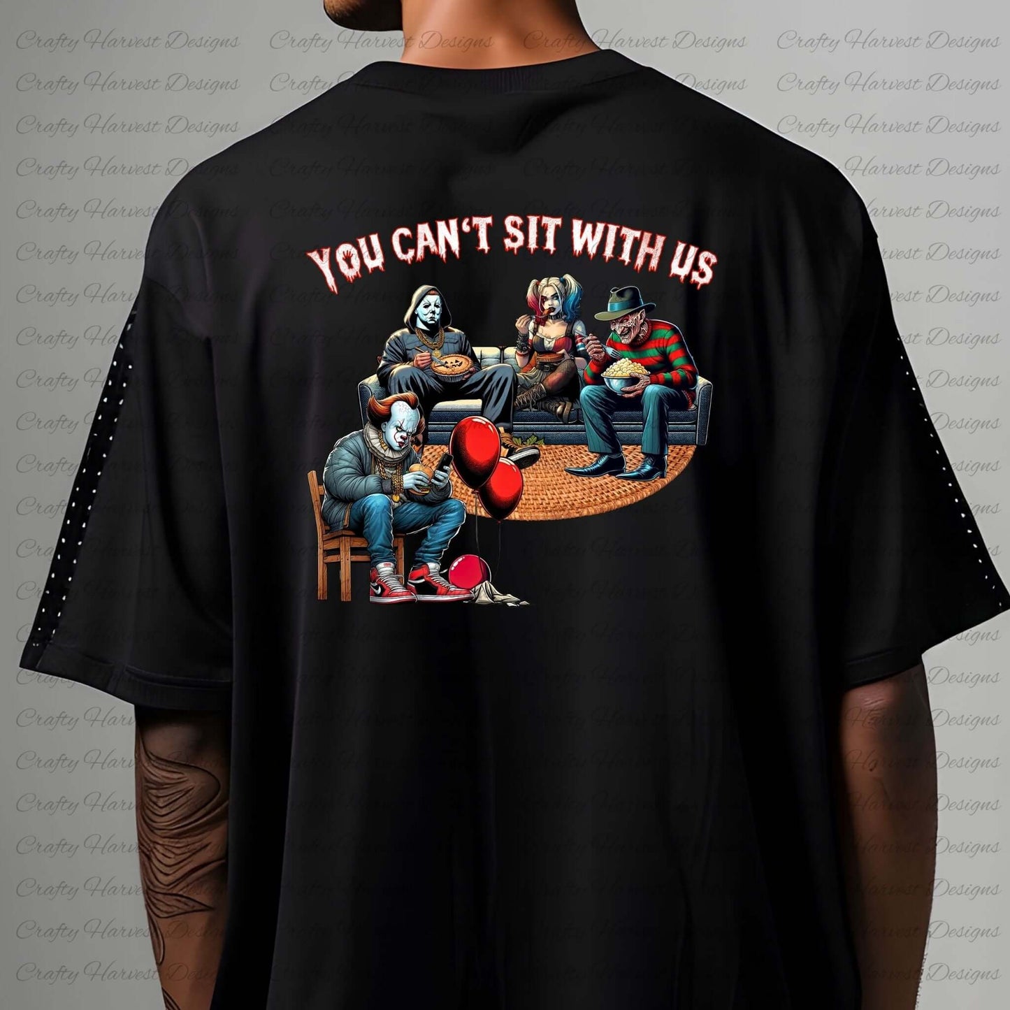 Mockup of the ‘You Can’t Sit With Us’ horror design featuring iconic characters lounging together on the back of a black shirt.