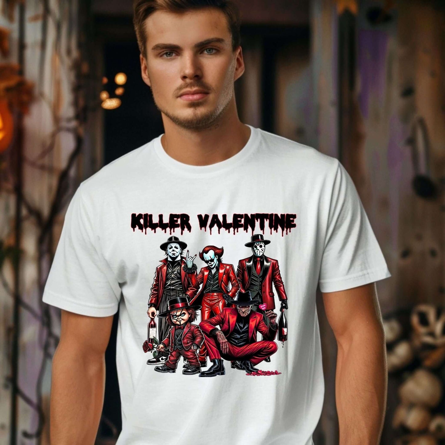 Man wearing a white t-shirt featuring a horror-themed Valentine’s Day design with the text “Killer Valentine” in a dripping font and a group of horror characters in red suits.