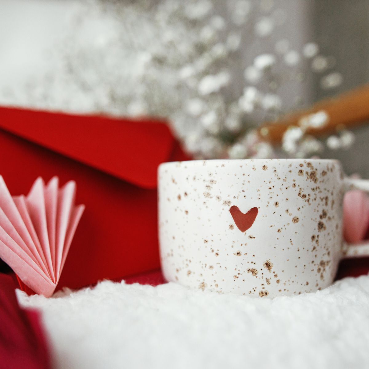 Whitewashed wooden plank background with a faint pink heart in the center