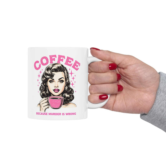 White ceramic mug featuring a retro design with ‘Coffee - Because Murder Is Wrong’ text in pink and an illustrated vintage-style woman holding a coffee cup.