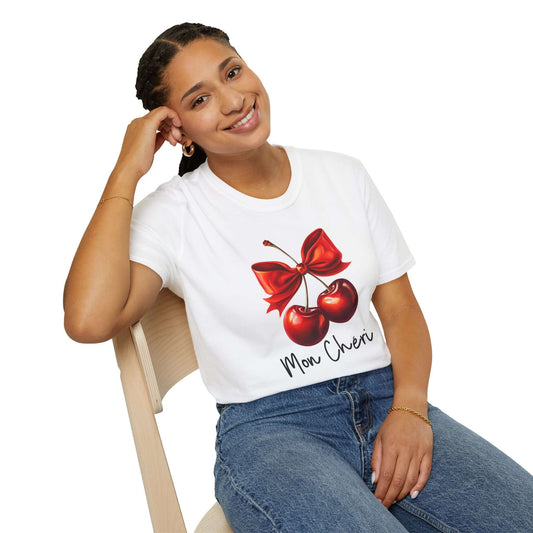 Smiling woman wearing a white unisex t-shirt featuring a stylish ‘Mon Chéri’ design with two vibrant red cherries tied with a bow and elegant text.