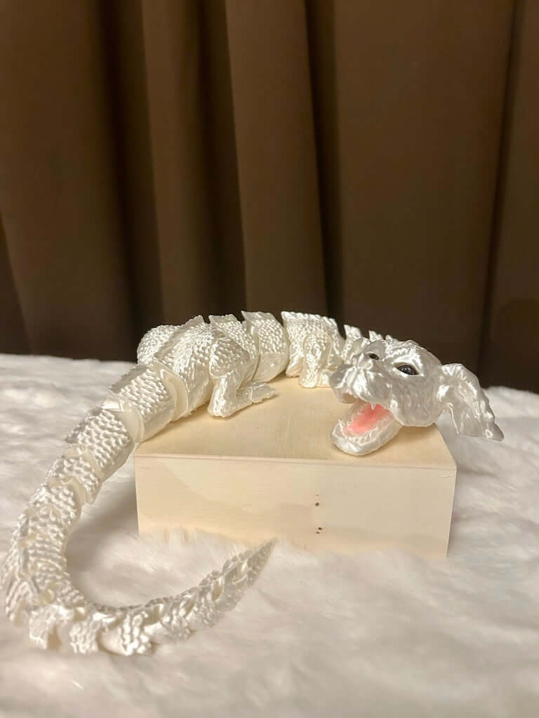 Decorative white dragon figure on a wooden base with a brown curtain background