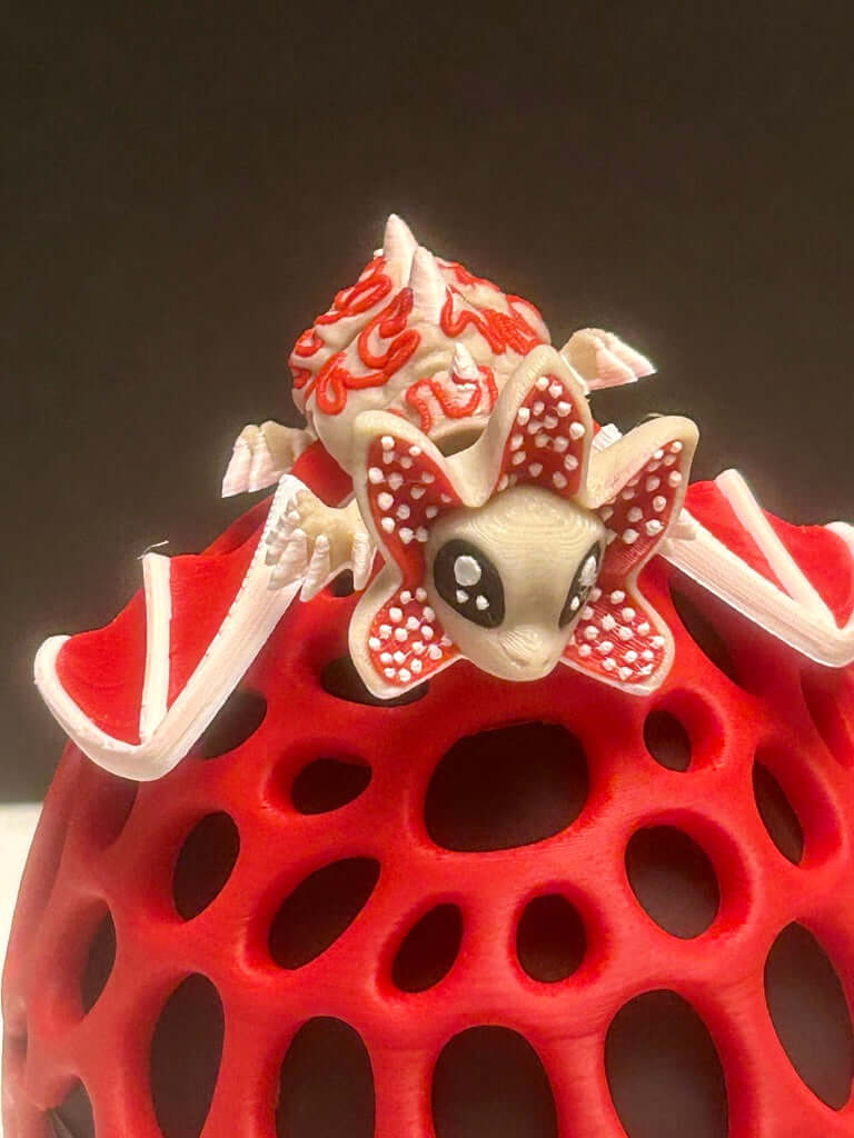 Red textured ball with a white and red character on top