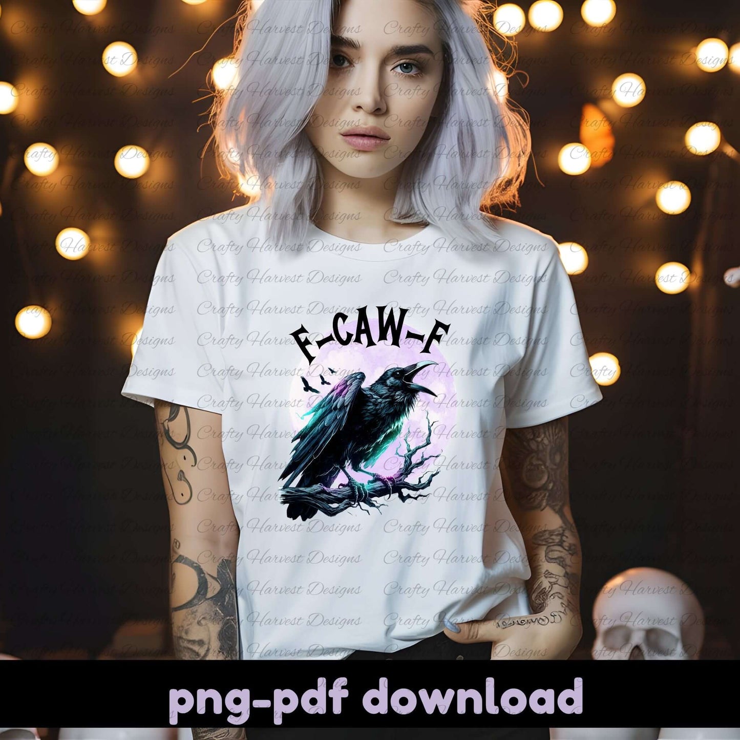Person wearing a white t-shirt with a crow design and text, standing against a string of lights.