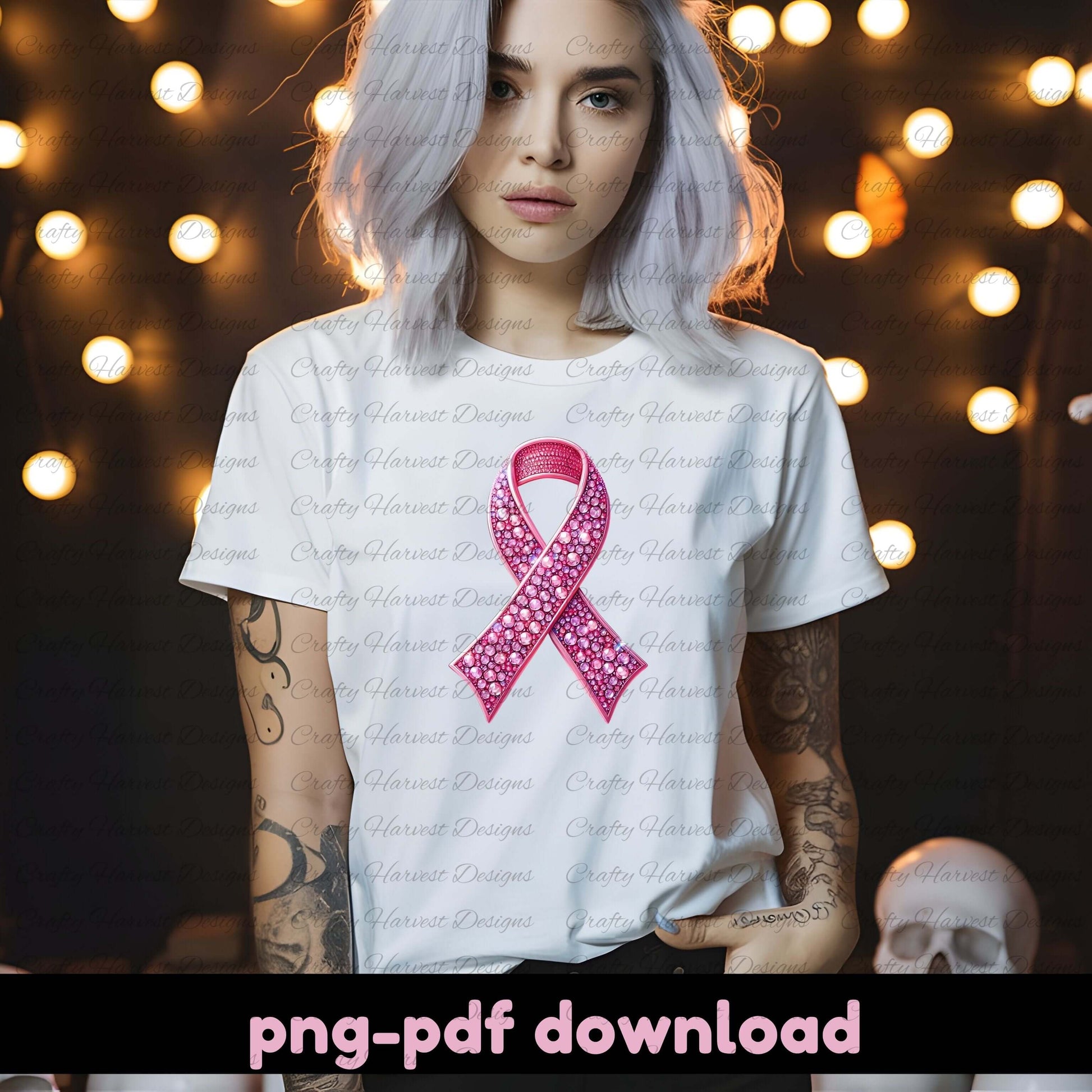 Person wearing a white t-shirt with a pink ribbon design against a blurred background with lights.
