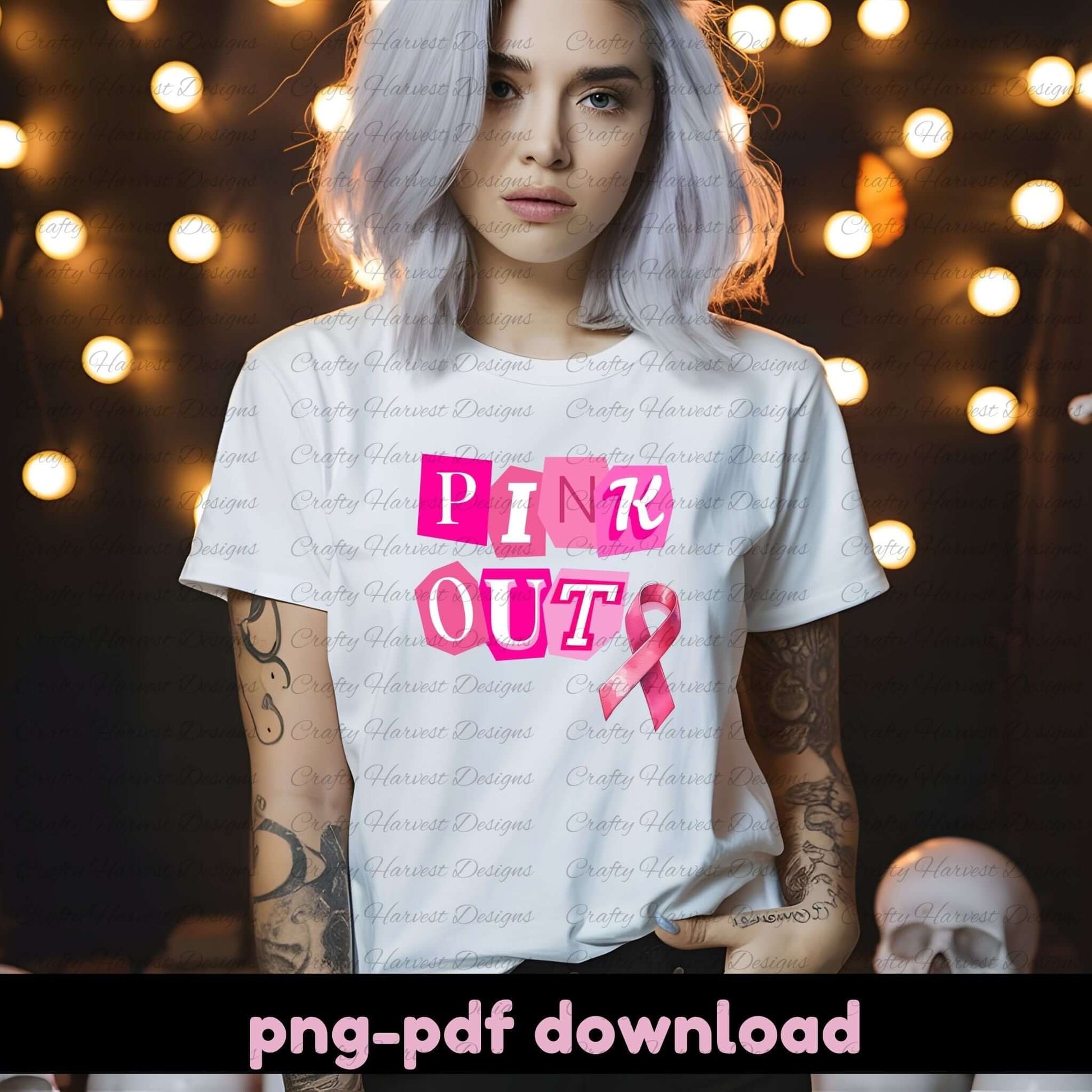 Person wearing a white t-shirt with 'Pink Out' text and pink ribbon graphic, with blurred lights in the background.