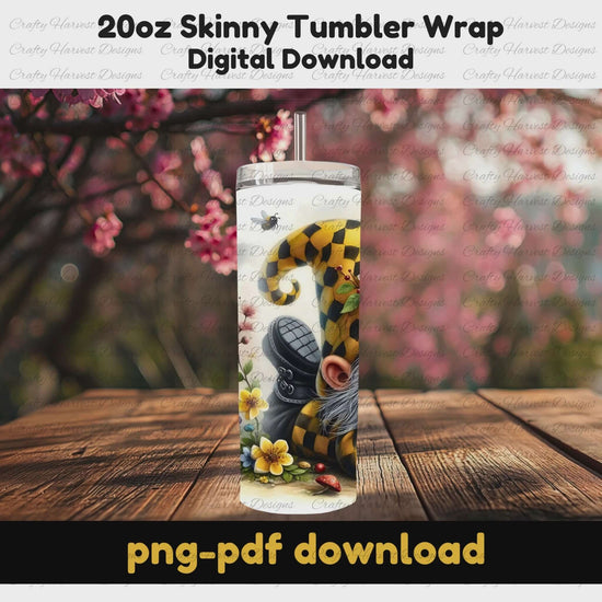 Rotating mockup of a 20oz skinny tumbler wrap featuring a bee gnome with a yellow checkered hat, surrounded by flowers and bees. The tumbler is displayed outdoors with cherry blossoms in the background. Text overlay reads ‘20oz Skinny Tumbler Wrap, Digital Download, png-pdf download.