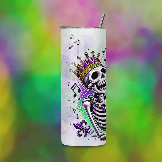 Video preview of a 20oz skinny tumbler featuring a saxophone-playing skeleton wearing a crown with beads and music notes in Mardi Gras colors of purple, green, and gold. Designed for sublimation projects.